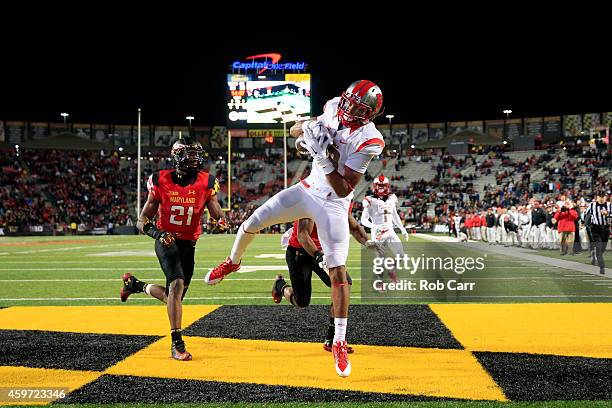 Wide receiver Andre Patton of the Rutgers Scarlet Knights catches a fourth quarter touchdown pass in front of defensive backs Sean Davis and William...