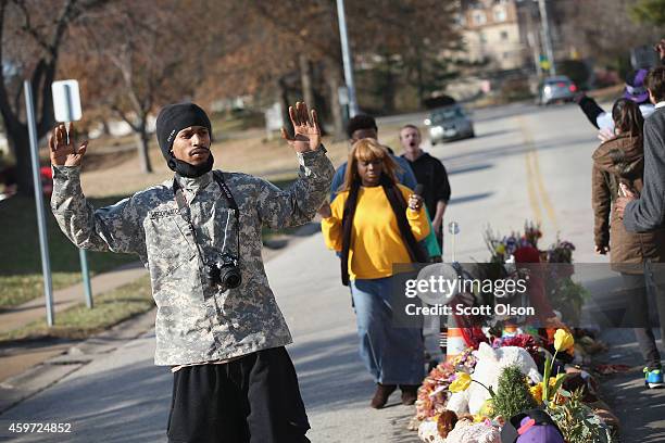 David Whitt and others march around the Michael Brown memorial on November 29, 2014 in Ferguson, Missouri. The Ferguson area has been struggling to...