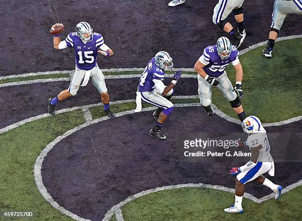 Quarterback Jake Waters of the Kansas State Wildcats throws a pass down field against the Kansas Jayhawks during the first half on November 29, 2014...