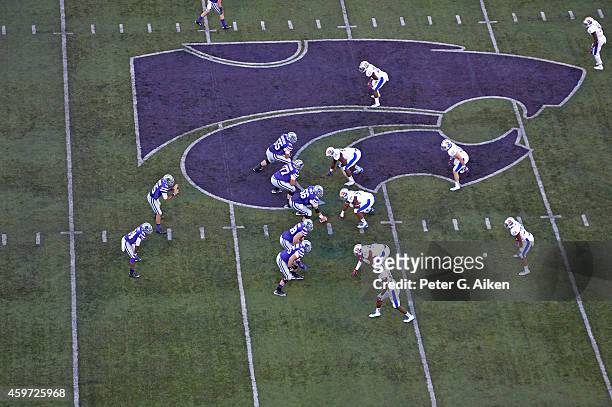 Quarterback Jake Waters of the Kansas State Wildcats calls out a play against the Kansas Jayhawks during the first half on November 29, 2014 at Bill...