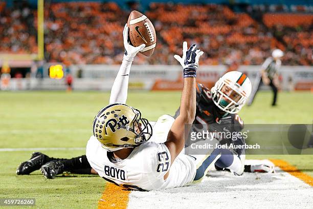 Corn Elder of the Miami Hurricanes looks back as Tyler Boyd of the Pittsburgh Panthers hold the ball up in the air, but the pass in the end zone was...