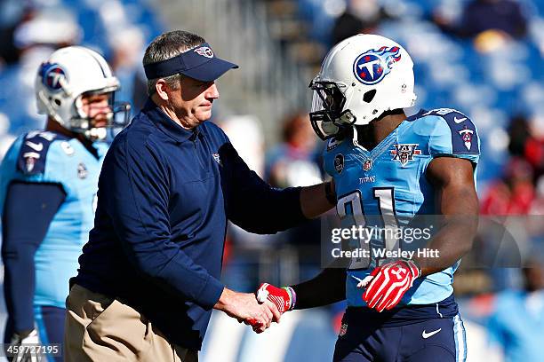 Head Coach Mike Munchak of the Tennessee Titans shakes hands with Bernard Pollard before a game against the Houston Texans at LP Field on December...