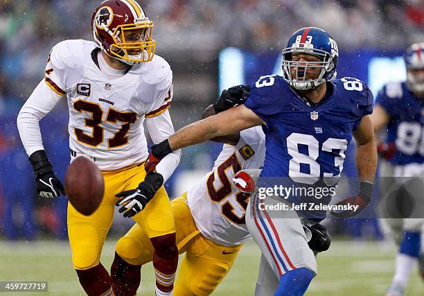 Brandon Myers of the New York Giants breaks up a pass intended for Reed Doughty of the Washington Redskins during their game at MetLife Stadium on...