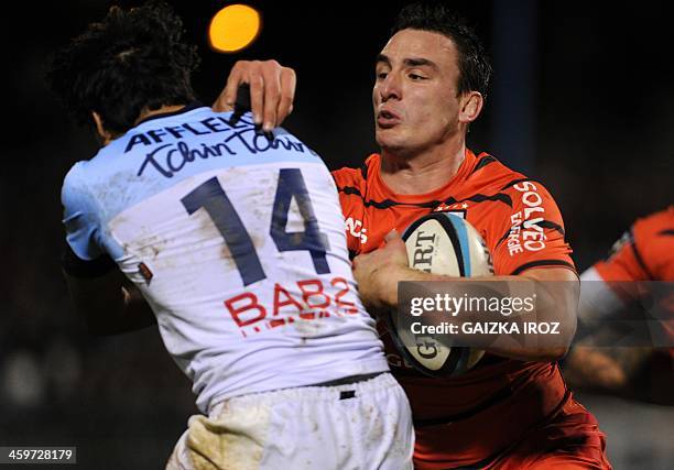 Toulouse's number eight Louis Picamoles vies with Bayonne's Argentinian winger Martin Bustos Moyano during the French Top rugby union match Aviron...