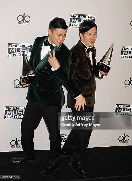 Singers Xiao Yang and Wang Taili of the Chopstick Brothers pose in the press room at the 2014 American Music Awards at Nokia Theatre L.A. Live on...