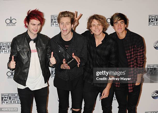 Musicians Michael Clifford, Luke Hemmings, Calum Hood and Ashton Irwin of 5 Seconds of Summer pose in the press room at the 2014 American Music...