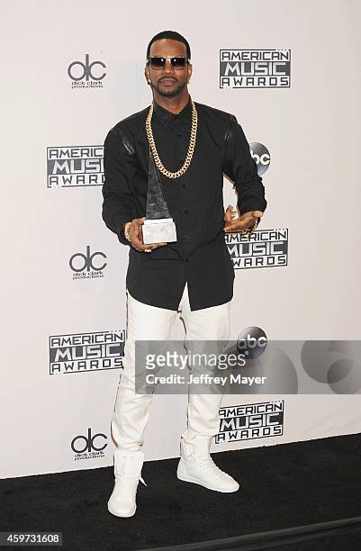 Rapper Juicy J, co-winner of Single of the Year for 'Dark Horse,' poses in the press room at the 2014 American Music Awards at Nokia Theatre L.A....