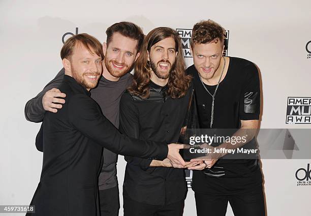 Musicians Ben McKee, Daniel Platzman, Daniel Wayne Sermon and Dan Reynolds of Imagine Dragons pose in the press room at the 2014 American Music...