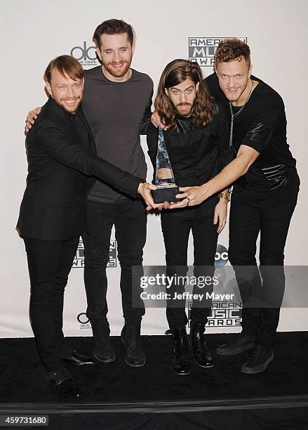 Musicians Ben McKee, Daniel Platzman, Daniel Wayne Sermon and Dan Reynolds of Imagine Dragons pose in the press room at the 2014 American Music...