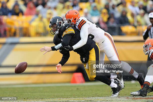 Ben Roethlisburgher of the Pittsburgh Steelers looses the ball as he is hit by Armonty Bryant of the Cleveland Browns during the game at Heinz Field...