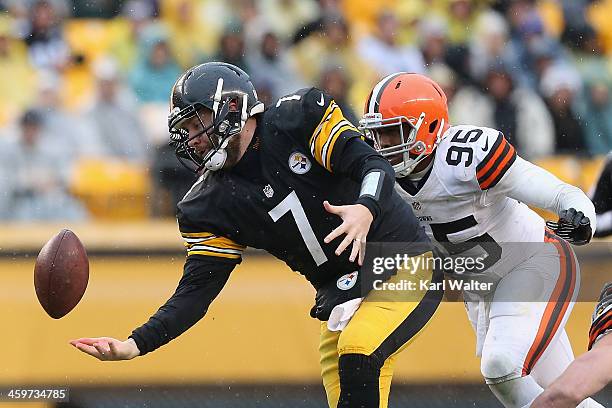 Ben Roethlisburgher of the Pittsburgh Steelers juggles the ball as he is hit by Armonty Bryant of the Cleveland Browns during the game at Heinz Field...