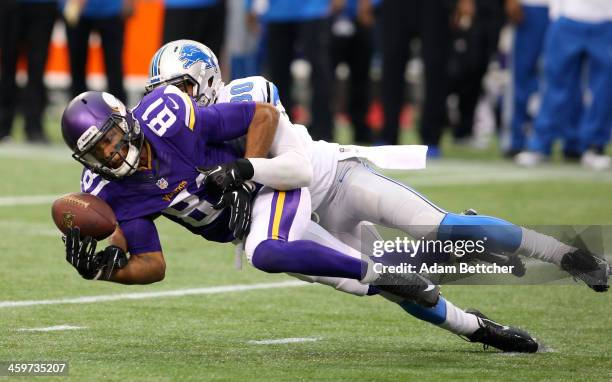 Jerome Simpson of the Minnesota Vikings gets tackled by Jonte Green of the Detroit Lions on December 29, 2013 at Mall of America Field at the Hubert...