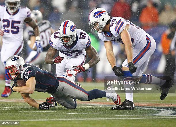 Julian Edelman of the New England Patriots catches a pass in front of Nigel Bradham and Kiko Alonso of the Buffalo Bills in the first half during the...