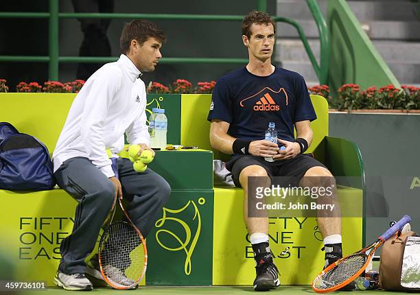 Andy Murray of Great Britain and one of his coaches, Daniel Vallverdu, practices prior to the Qatar ExxonMobil Open 2014 held at the Khalifa...