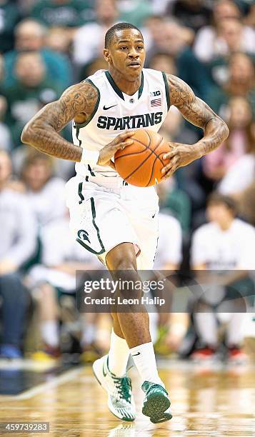 Keith Appling of the Michigan State Spartans brings the ball up the court during the second half of the game against the New Orleans Privateers at...