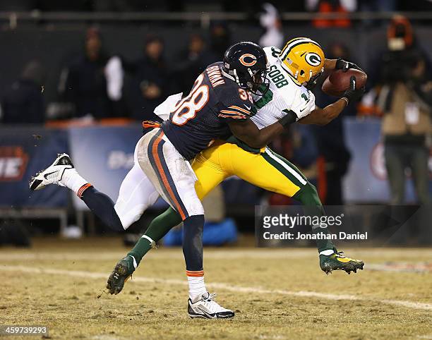 Randall Cobb of the Green Bay Packers dives across the goal line to score the game winning touchdown with Zack Bowman of the Chicago Bears on his...