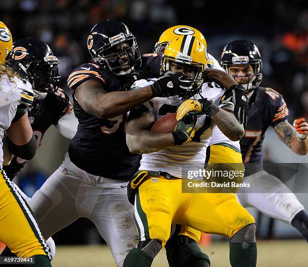 Corey Wootton of the Chicago Bears tackles Eddie Lacy of the Green Bay Packers during the fourth quarter on December 29, 2013 at Soldier Field in...