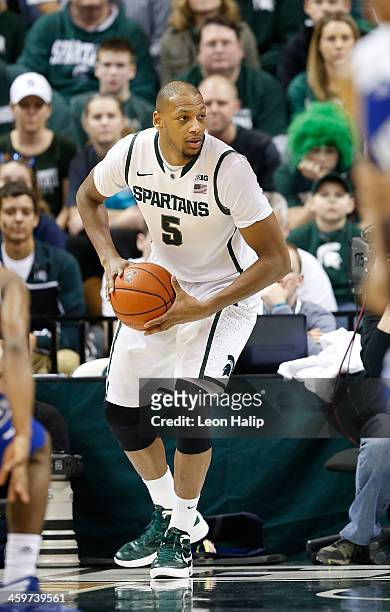 Adreian Payne of the Michigan State Spartans brings the ball up the court during the first half of the game against the New Orleans Privateers at the...