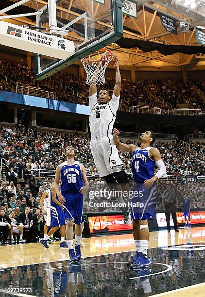 Adreian Payne of the Michigan State Spartans dunks the ball during the first half of the game against the New Orleans Privateers at the Breslin...