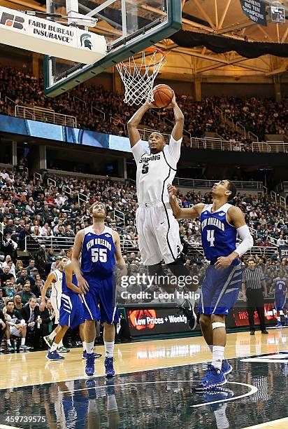 Adreian Payne of the Michigan State Spartans dunks the ball during the first half of the game against the New Orleans Privateers at the Breslin...