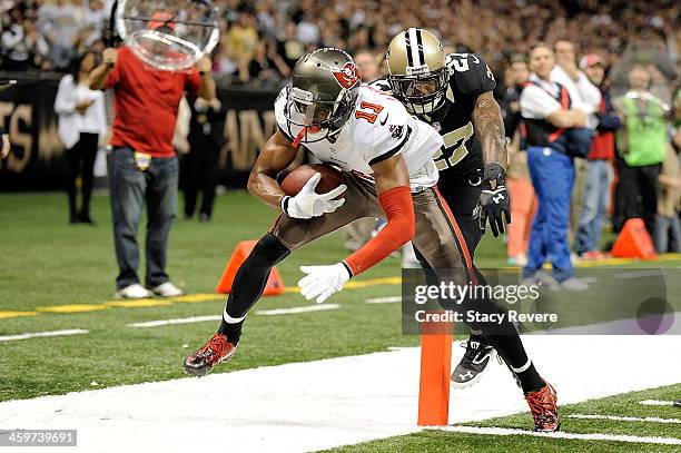 Tiquan Undrwood of the Tampa Bay Buccaneers is pushed out of bounds by Malcolm Jenkins of the New Orleans Saints during a game at the Mercedes-Benz...