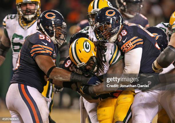 Eddie Lacy of the Green Bay Packers is hit by Lance Briggs, Shea McClellin and Corey Wootton of the Chicago Bears at Soldier Field on December 29,...