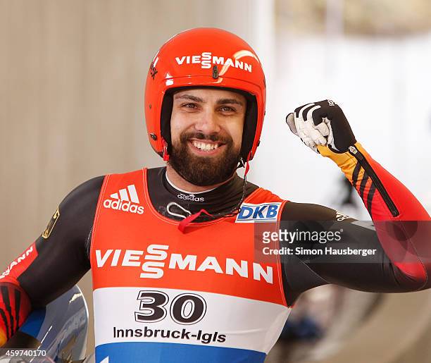 Andi Langenhan of Germany celebrates after taking the third place at the Viessmann Luge World Cup at Olympiabobbahn Igls on November 30, 2014 in...