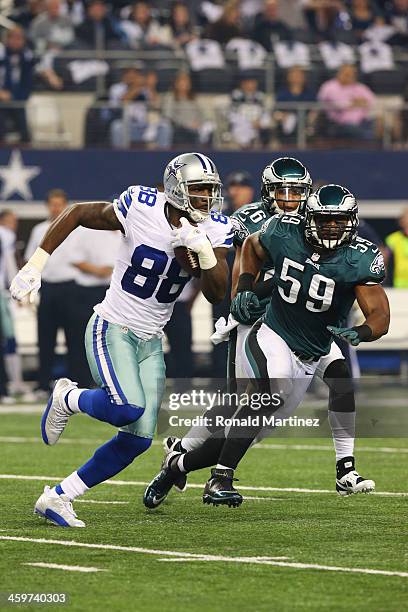 Dez Bryant of the Dallas Cowboys tries to avoid the tackle of DeMeco Ryans of the Philadelphia Eagles in the first quarter at Cowboys Stadium on...