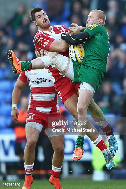 Tom Homer of London Irish and Mark Atkinson of Gloucester challenge for a high ball during the Aviva Premiership match between London Irish and...