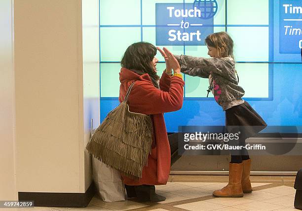 Milla Jovovich is sen at Los Angeles International Airport with her daughter, Ever Gabo Anderson on March 18, 2013 in Los Angeles, California.