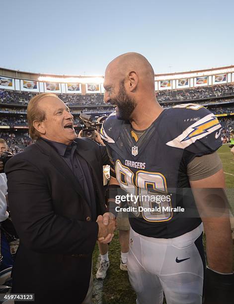 Team owner Dean Spanos of the San Diego Chargers celebrates with Jarret Johnson after a 27-24 overtime win against the Kansas City Chiefs during...