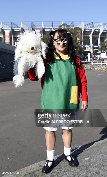 Girl dressed as "La Chilindrina", a character of the sitcom "El Chavo del Ocho", poses outside the 105,000-capacity Azteca stadium in Mexico City on...