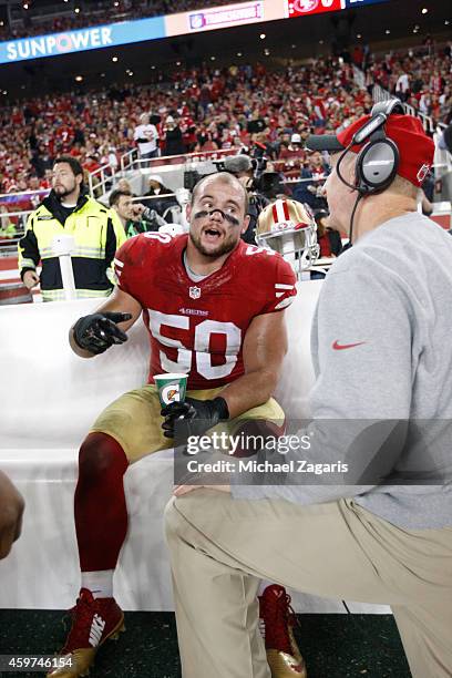 Linebackers Coach Jim Leavitt of the San Francisco 49ers talks with Chris Borland during the game against the Seattle Seahawks at Levi Stadium on...