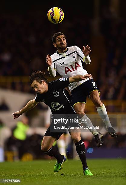 Aaron Lennon of Spurs climbs above Leighton Baines of Everton to win the ball during the Barclays Premier League match between Tottenham Hotspur and...