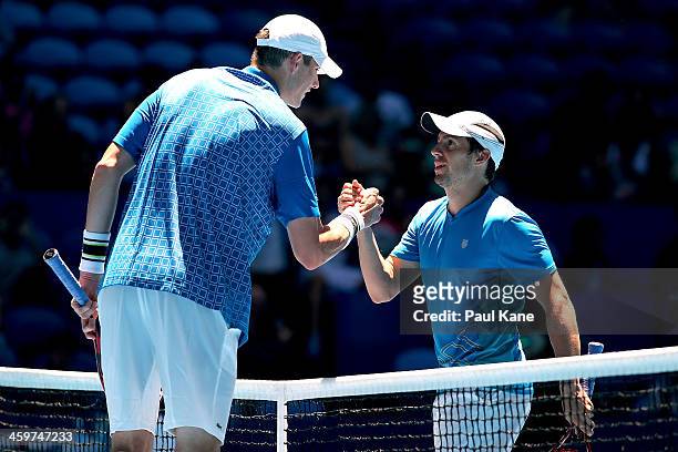 John Isner of the United States is congratulated by Daniel Munoz-De La Nava of Spain after winning the men's singles match during day three of the...