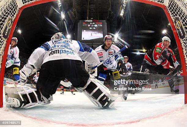 Christopher Minard of Koeln and Alexander Dueck of Schwenningen battle for the puck during the DEL match between Koelner Haie and Schwenninger Wild...