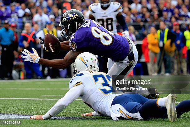 Wide receiver Torrey Smith of the Baltimore Ravens catches a touchdown over free safety Eric Weddle of the San Diego Chargers in the first quarter of...