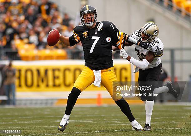 Ben Roethlisberger of the Pittsburgh Steelers avoids a tackle by Keenan Lewis of the New Orleans Saints during the first quarter at Heinz Field on...