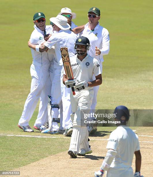 Rohit Sharma of India walks off as South Africa celebrate taking his wicket during day 5 of the 2nd Test match between South Africa and India at...