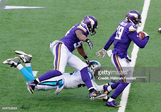 Jasper Brinkley of the Minnesota Vikings helps breakup a tackle attempt by Thomas DeCoud of the Carolina Panthers as Adam Thielen of the Minnesota...