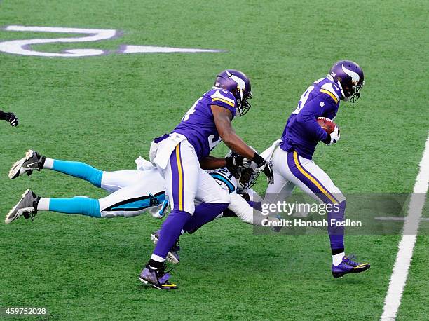 Jasper Brinkley of the Minnesota Vikings helps breakup a tackle attempt by Thomas DeCoud of the Carolina Panthers as Adam Thielen of the Minnesota...