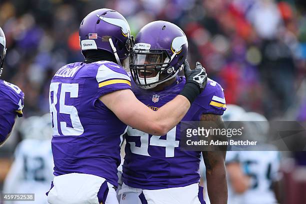 Jasper Brinkley and Rhett Ellison of the Minnesota Vikings celebrate a touchdown against the Carolina Panthers in the second quarter on November 30,...