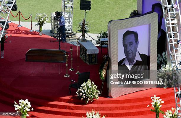 The coffin of Mexican comedian Roberto Gomez Bolanos is seen next to a giant portrait during an homage at the 105,000-capacity Azteca stadium in...