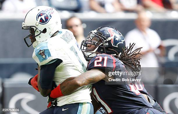 Kendall Wright of the Tennessee Titans father a touchdown pass while Kendrick Lewis of the Houston Texans defends in the third quarter in a NFL game...