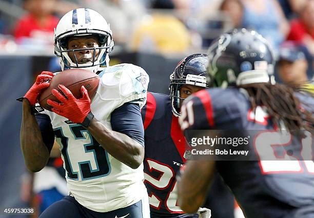 Kendall Wright of the Tennessee Titans catches a touchdown pass while Kendrick Lewis of the Houston Texans defends in the third quarter in a NFL game...