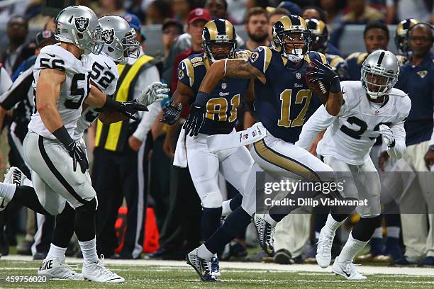 Stedman Bailey of the St. Louis Rams runs up fireld after making a catch against Khalil Mack, Miles Burris, and Tarell Brown of the Oakland Raiders...