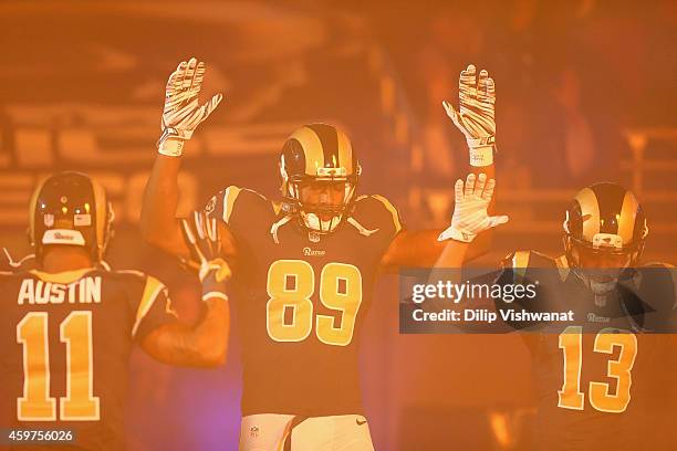 Tavon Austin, Jared Cook, Chris Givens of the St. Louis Rams pay homage to Mike Brown by holding their hands up during their pre-game introduction...