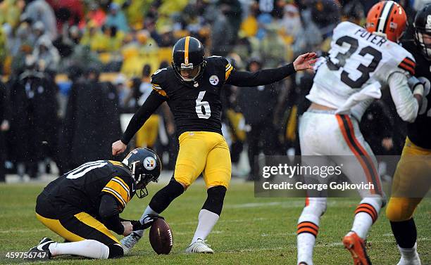 Kicker Shaun Suisham of the Pittsburgh Steelers kicks an extra point on a hold by Mat McBriar during a game against the Cleveland Browns at Heinz...