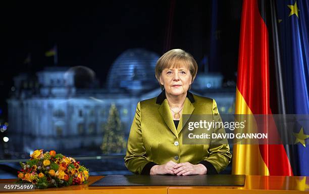 German Chancellor Angela Merkel poses for a photograph after the recording of her annual New Year's speech at the Chancellery in Berlin on December...