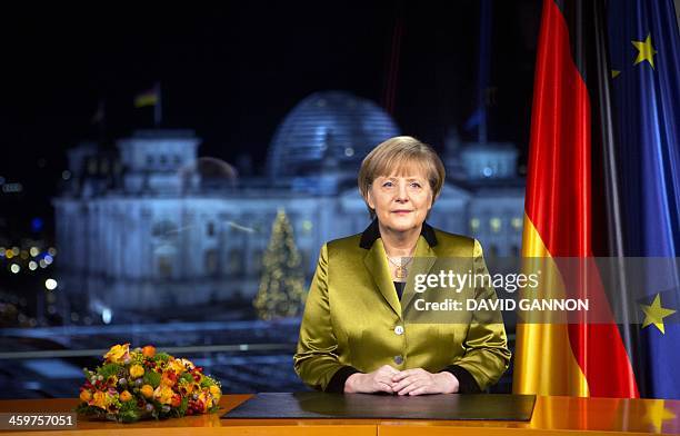 German Chancellor Angela Merkel poses for a photograph after the recording of her annual New Year's speech at the Chancellery in Berlin on December...